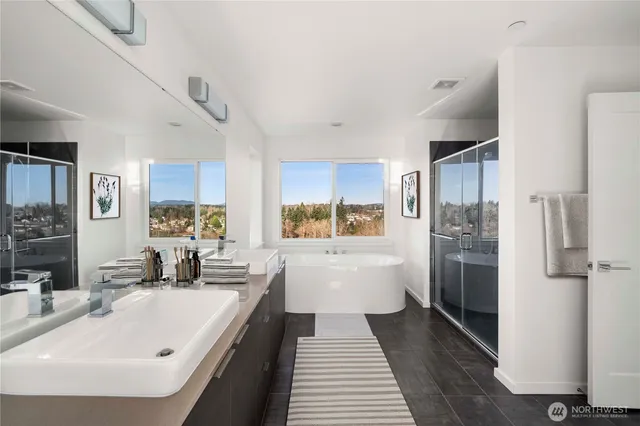 a large white kitchen with a white stove top oven and refrigerator