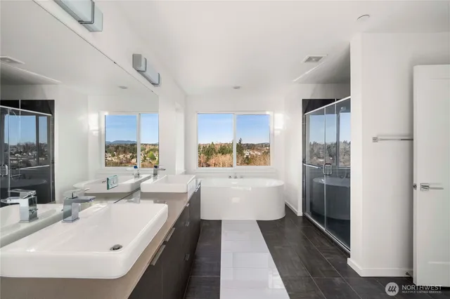 a large white kitchen with a white stove top oven and sink