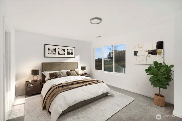 a bedroom with a large bed and a potted plant