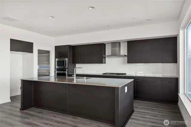 a kitchen with stainless steel appliances a stove and a microwave