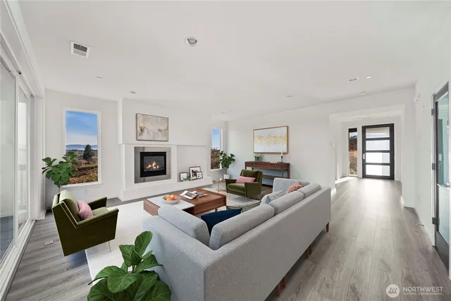 a living room with fireplace furniture and a wooden floor