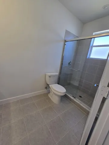 a bathroom with a shower and a toilet