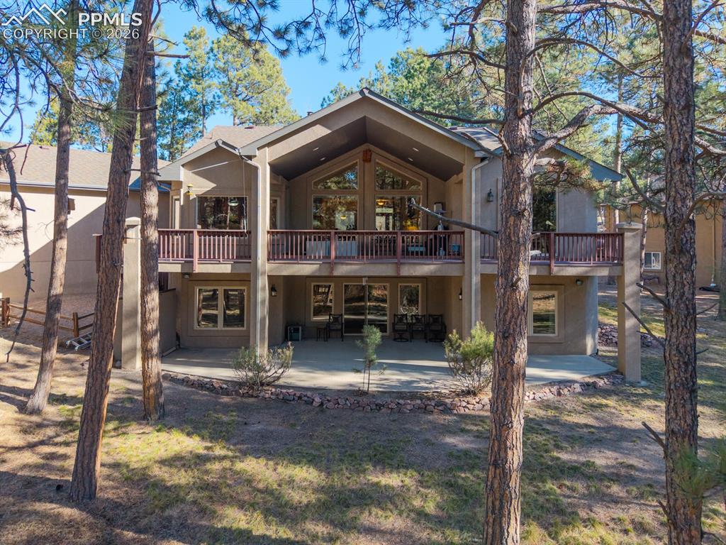 17990 Sawmill Road Colorado Springs, CO 80908 - Photo 8 of 40 Full-width deck and patio on back side