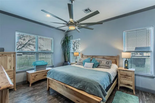 a bedroom with a bed and a chandelier