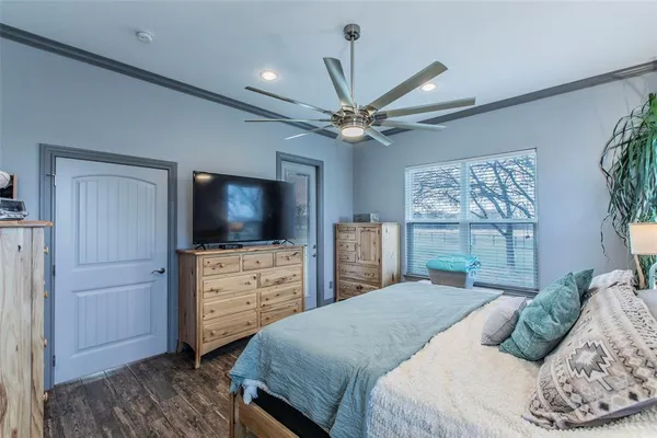 a bedroom with a large bed and a flat screen tv