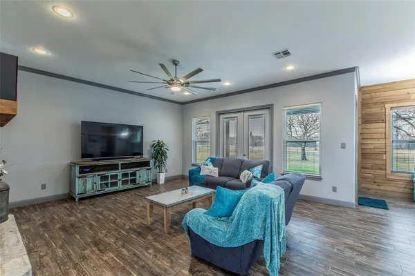 a living room with furniture and a flat screen tv