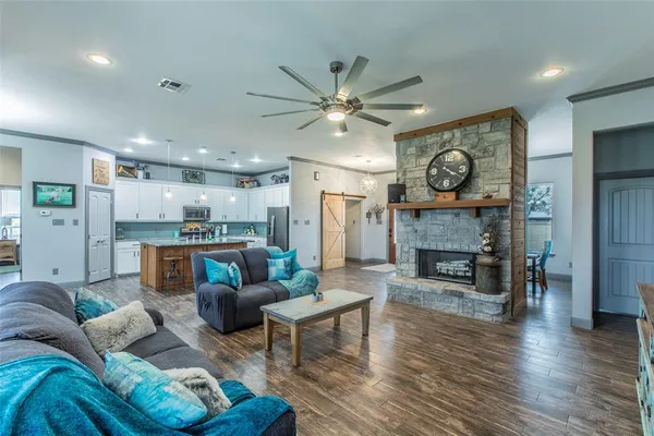 a living room with furniture and a fireplace