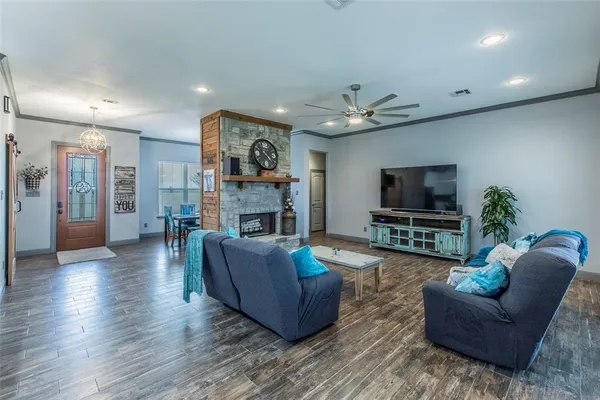 a living room with furniture a flat screen tv and a fireplace