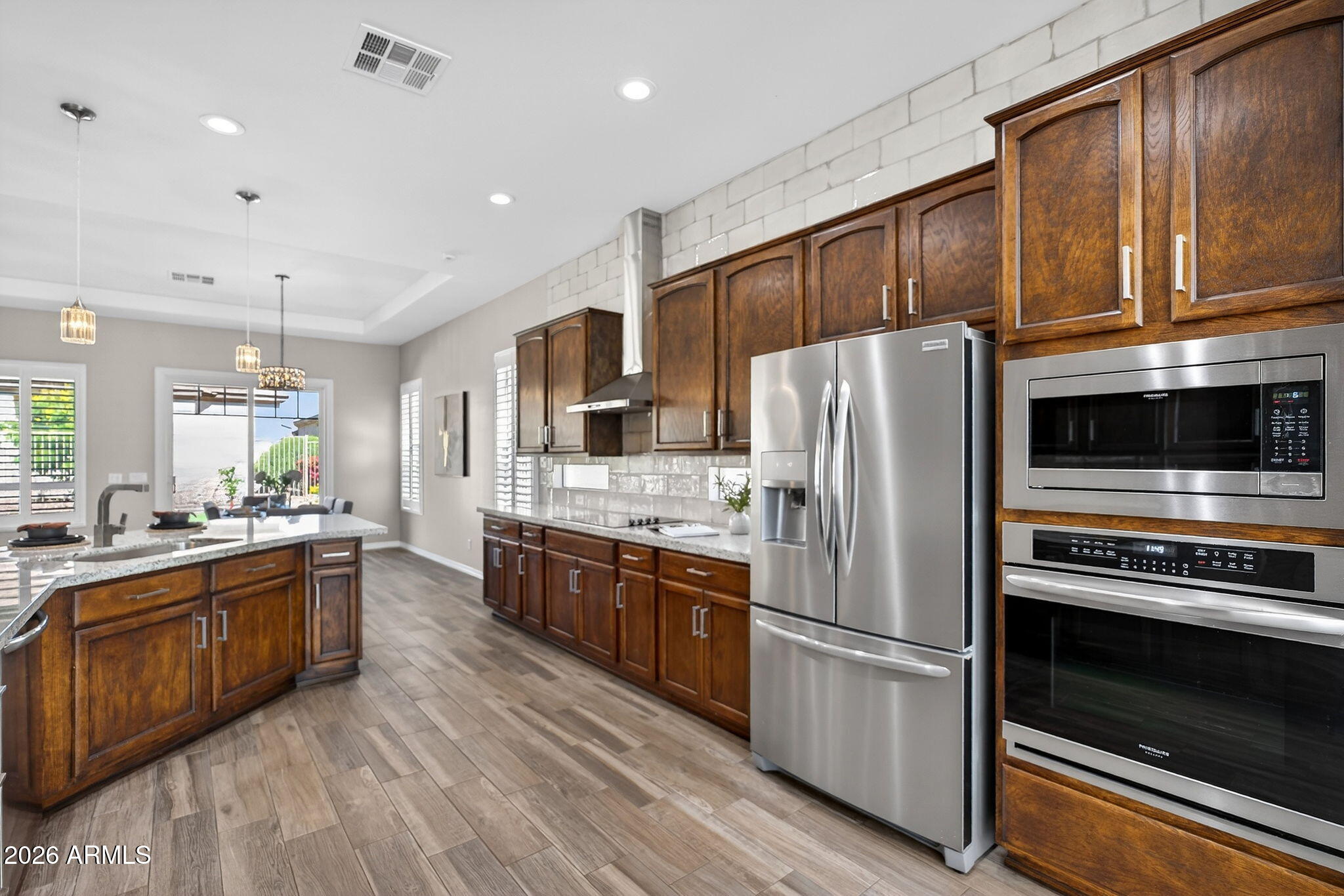 4128 East Jude Lane Gilbert, AZ 85298 - Photo 13 of 58 a kitchen with granite countertop stainless steel appliances and wooden cabinets