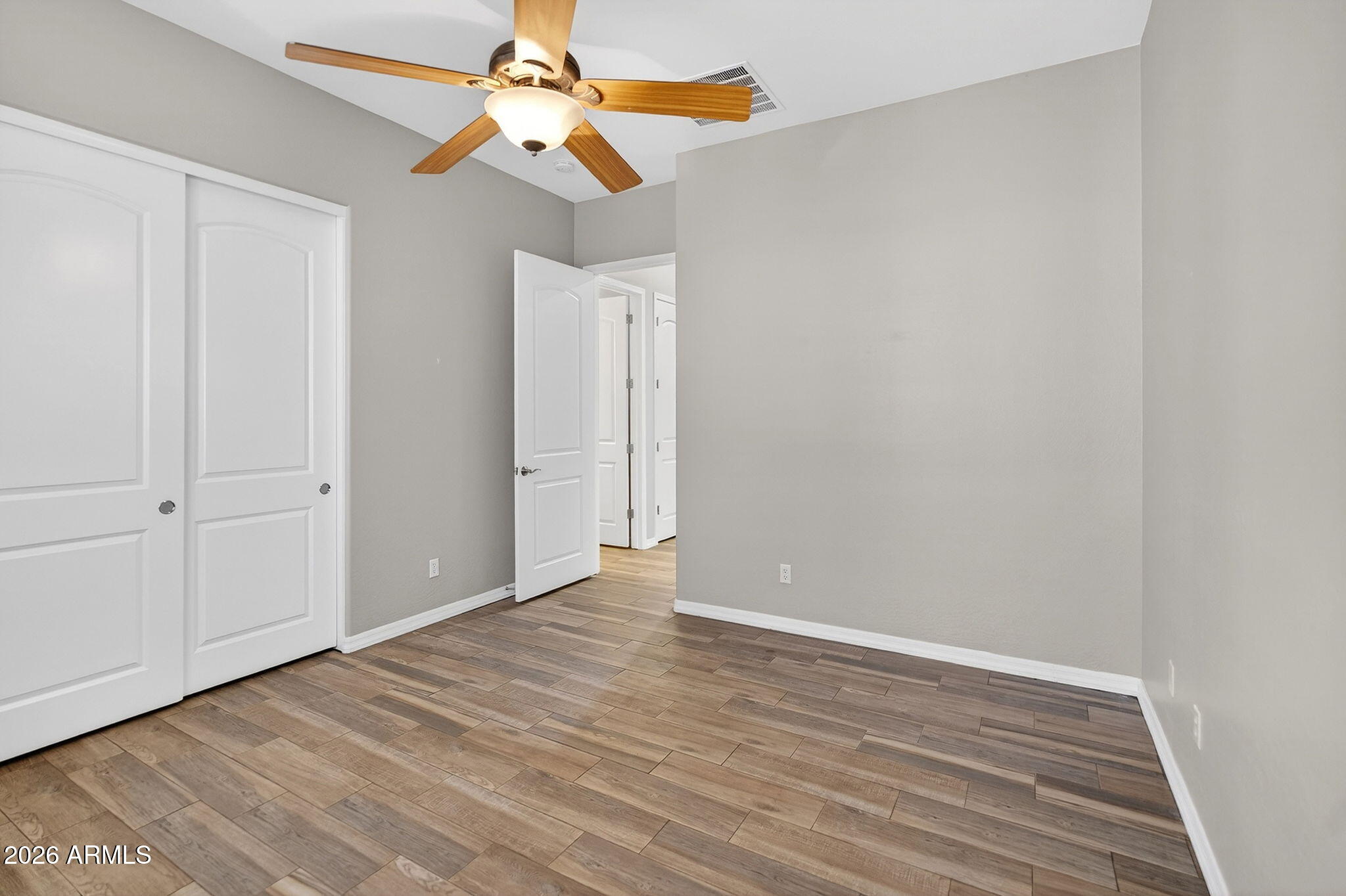 4128 East Jude Lane Gilbert, AZ 85298 - Photo 33 of 58 a view of an empty room with window and wooden floor