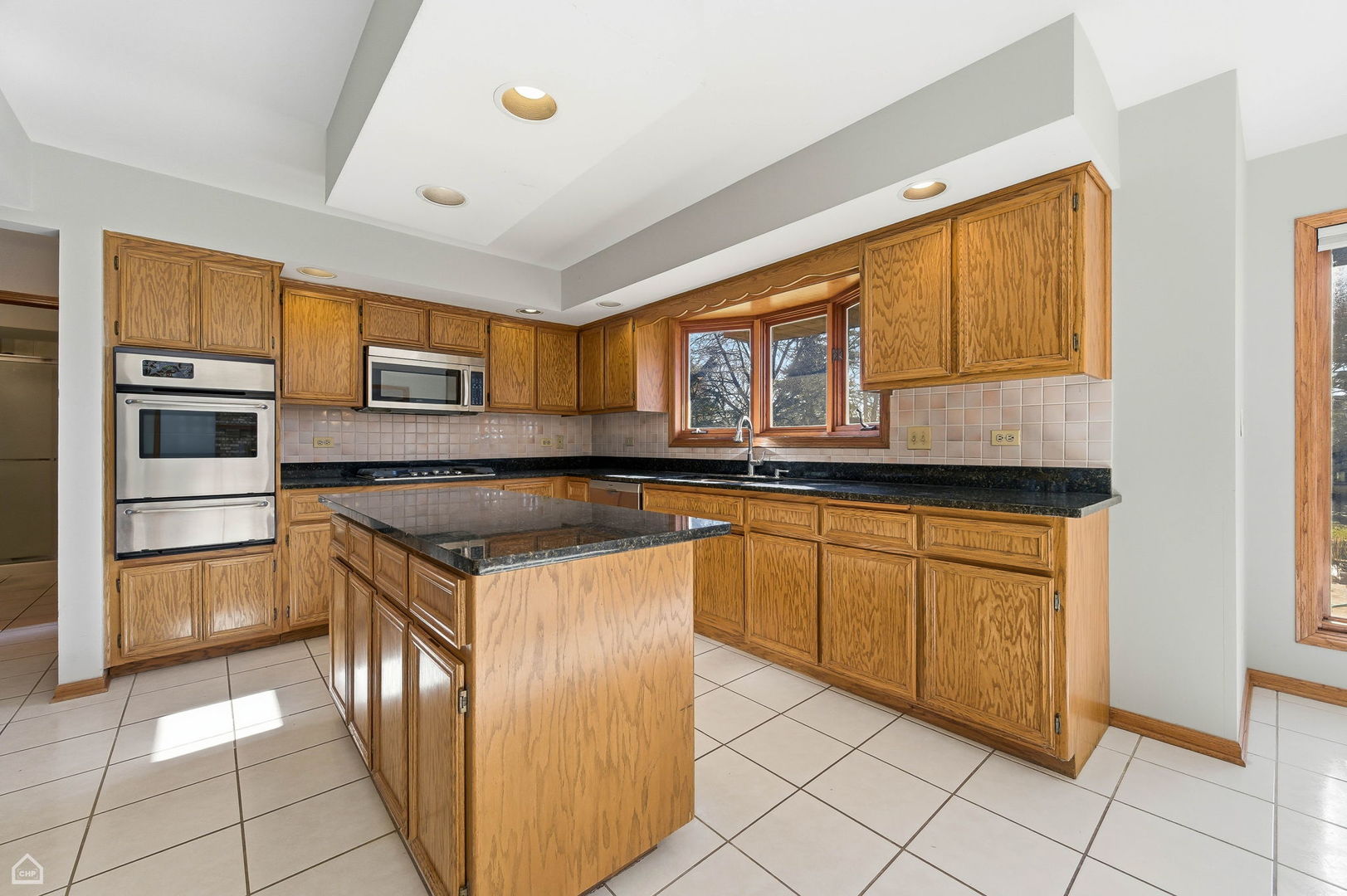 13725 Kit Lane Lemont, IL 60439 - Photo 12 of 61 a kitchen with stainless steel appliances granite countertop a stove a sink and a microwave