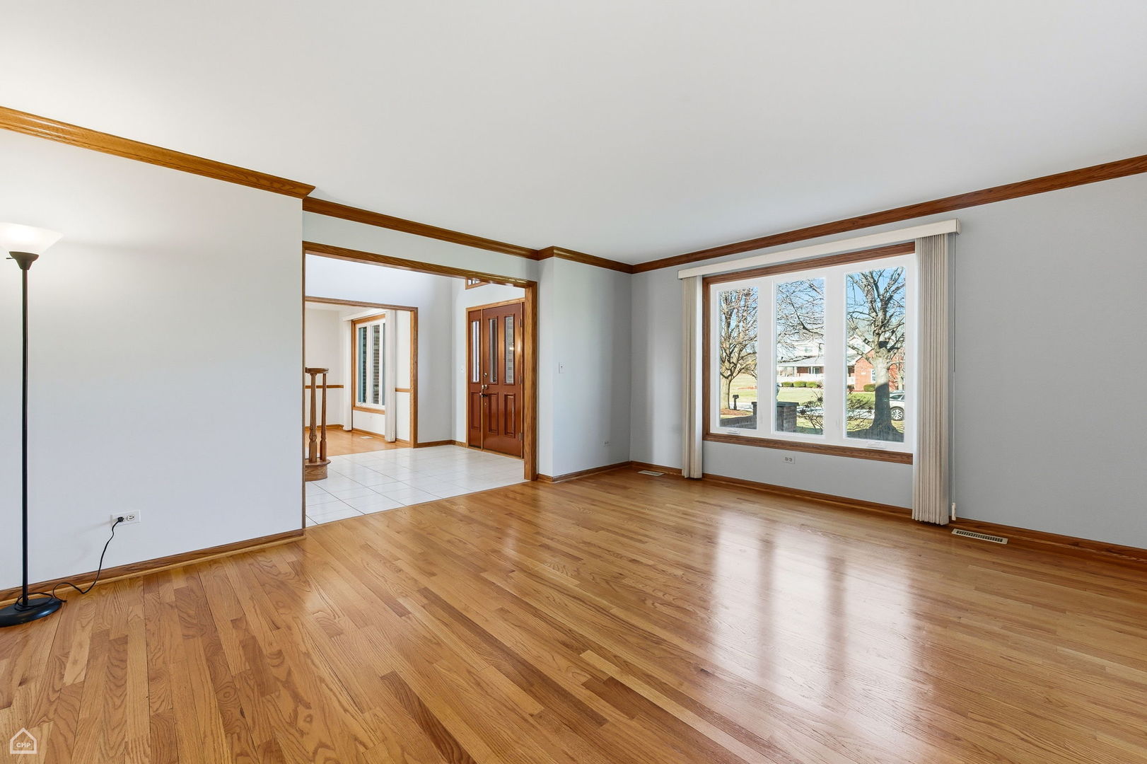 13725 Kit Lane Lemont, IL 60439 - Photo 17 of 61 a view of an empty room with wooden floor and a window