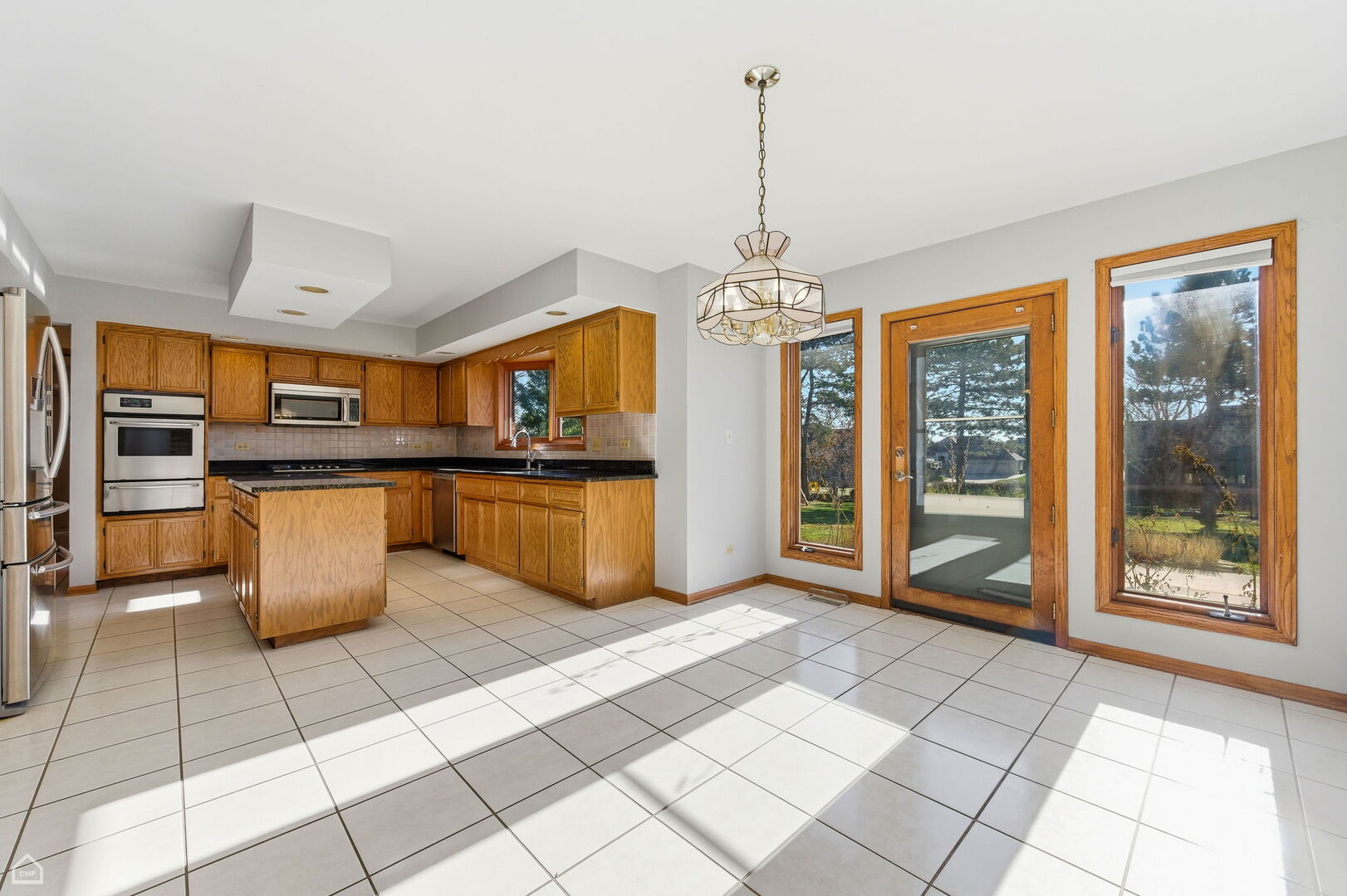 13725 Kit Lane Lemont, IL 60439 - Photo 3 of 61 a kitchen with stainless steel appliances granite countertop a stove a sink dishwasher and cabinets
