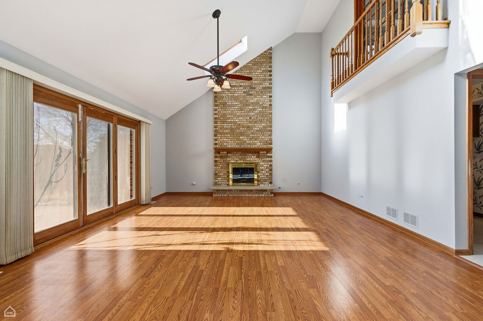 13725 Kit Lane Lemont, IL 60439 - Photo 6 of 61 a view of an empty room with wooden floor fireplace and a window