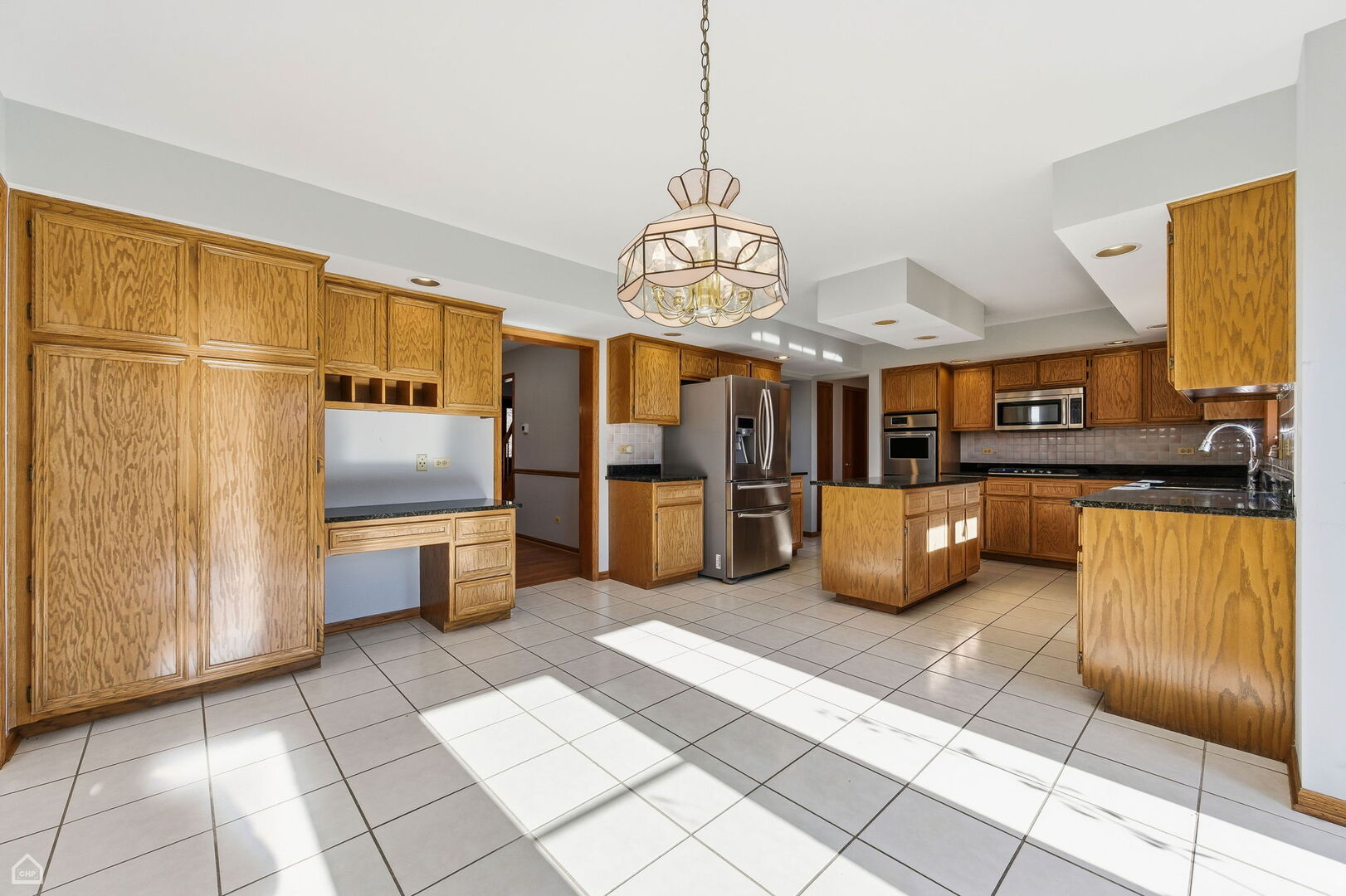 13725 Kit Lane Lemont, IL 60439 - Photo 10 of 61 a kitchen with stainless steel appliances kitchen island granite countertop a refrigerator and a sink