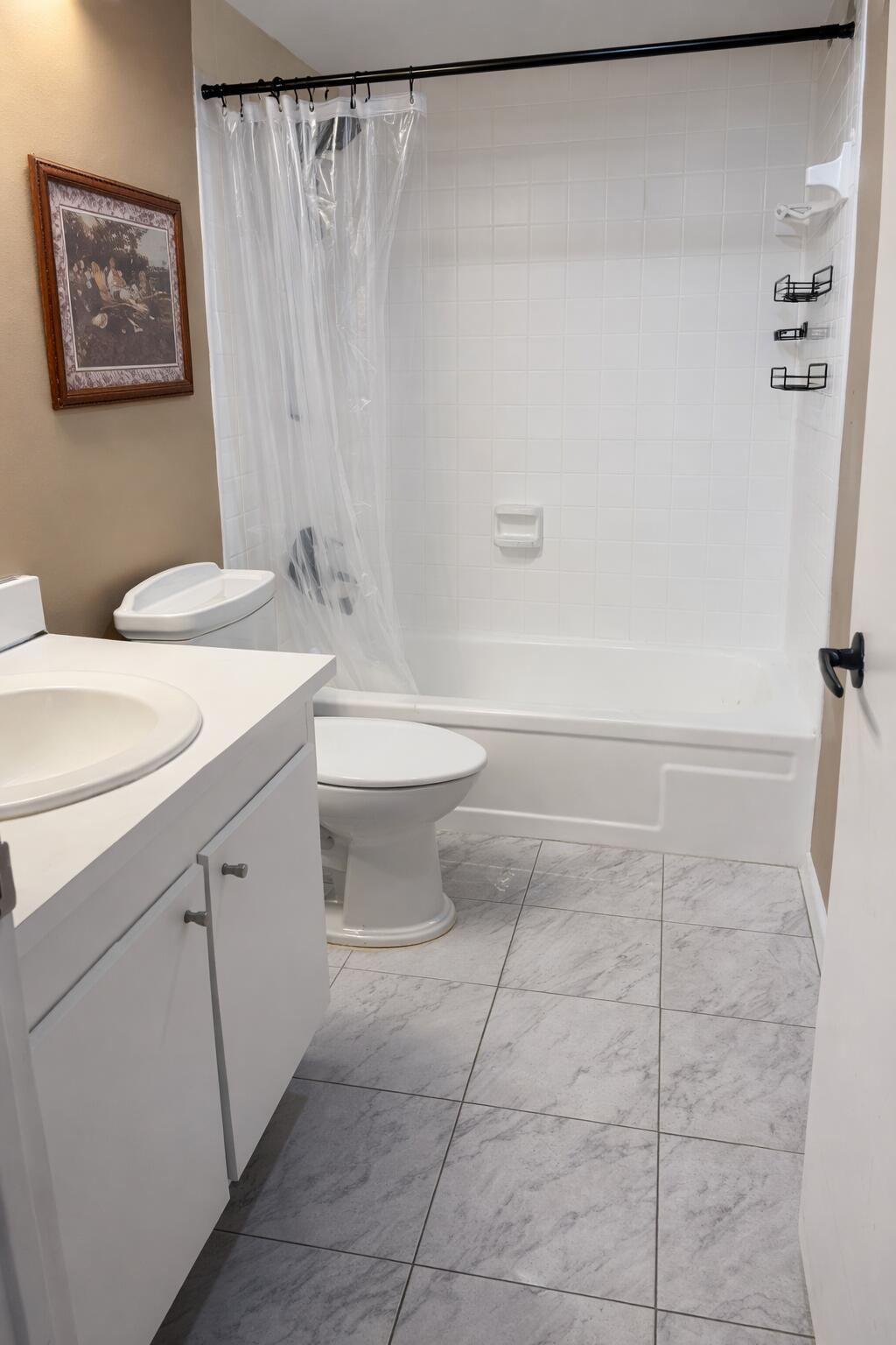 2001 Woolbright Road, Unit F204 Boynton Beach, FL 33426 - Photo 7 of 7 a bathroom with a toilet a sink and a shower