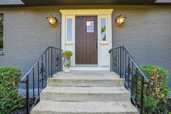 a view of front door of house with stairs