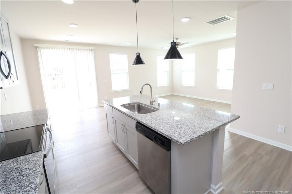104 Kineton Woods Way Garner, NC 27529 - Photo 12 of 43 a kitchen with a sink a counter space and a window