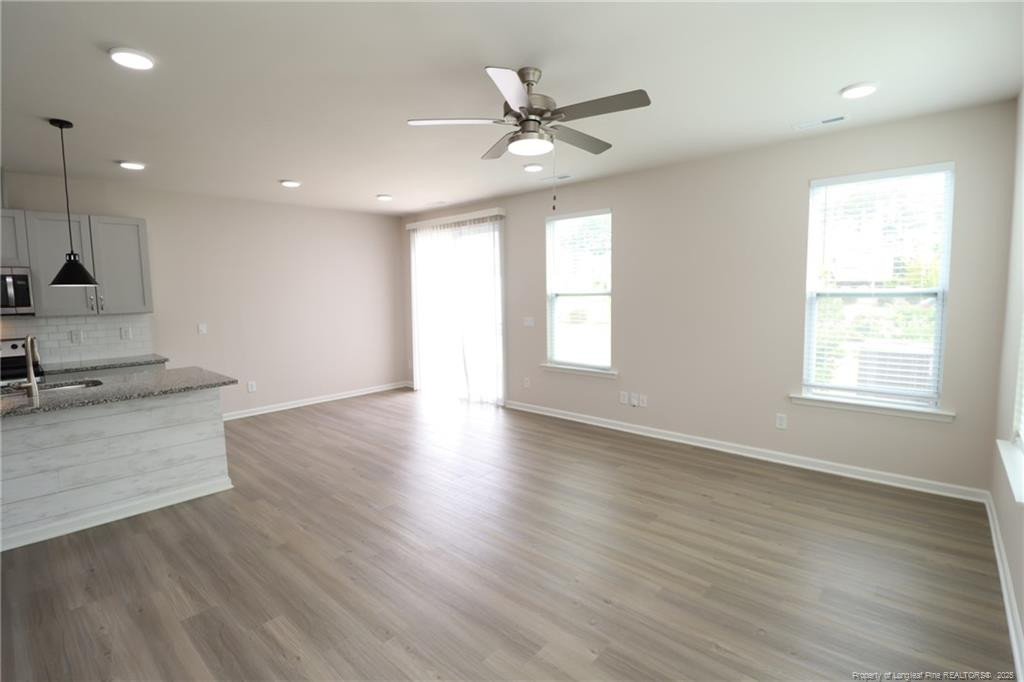 104 Kineton Woods Way Garner, NC 27529 - Photo 15 of 43 wooden floor in an empty room with a window