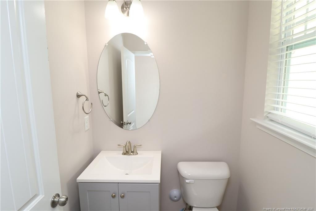 104 Kineton Woods Way Garner, NC 27529 - Photo 21 of 43 a bathroom with a toilet sink and mirror