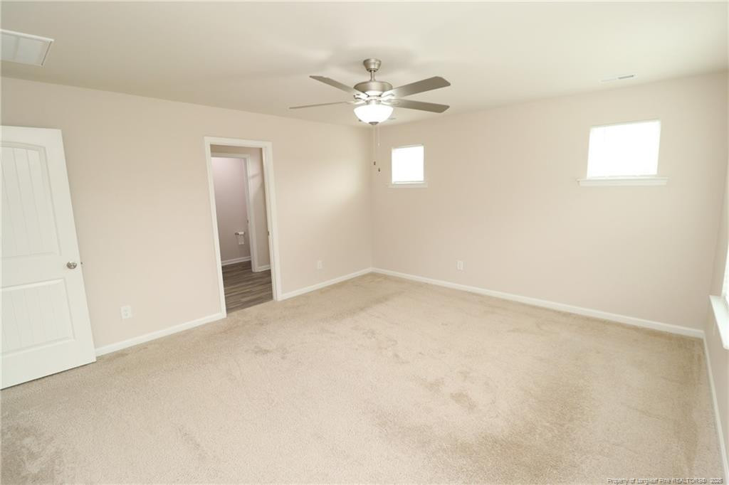 104 Kineton Woods Way Garner, NC 27529 - Photo 28 of 43 an empty room with windows and fan