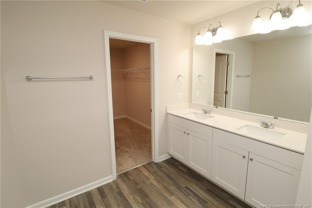 104 Kineton Woods Way Garner, NC 27529 - Photo 29 of 43 a bathroom with a double vanity sink and mirror