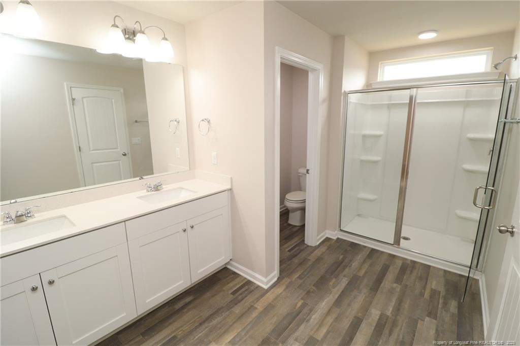 104 Kineton Woods Way Garner, NC 27529 - Photo 30 of 43 a spacious bathroom with a shower sink and mirror