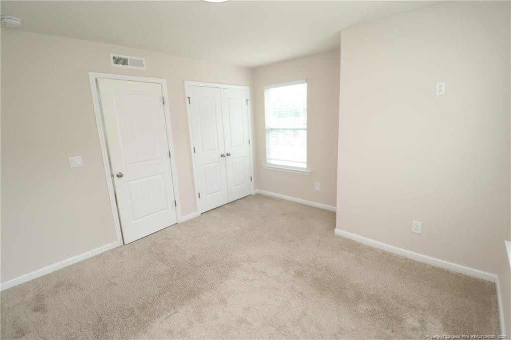 104 Kineton Woods Way Garner, NC 27529 - Photo 35 of 43 an empty room with windows