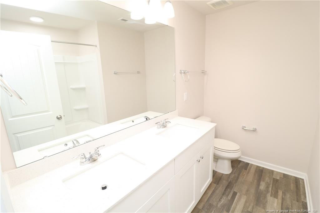 104 Kineton Woods Way Garner, NC 27529 - Photo 40 of 43 a bathroom with a sink a toilet and shower