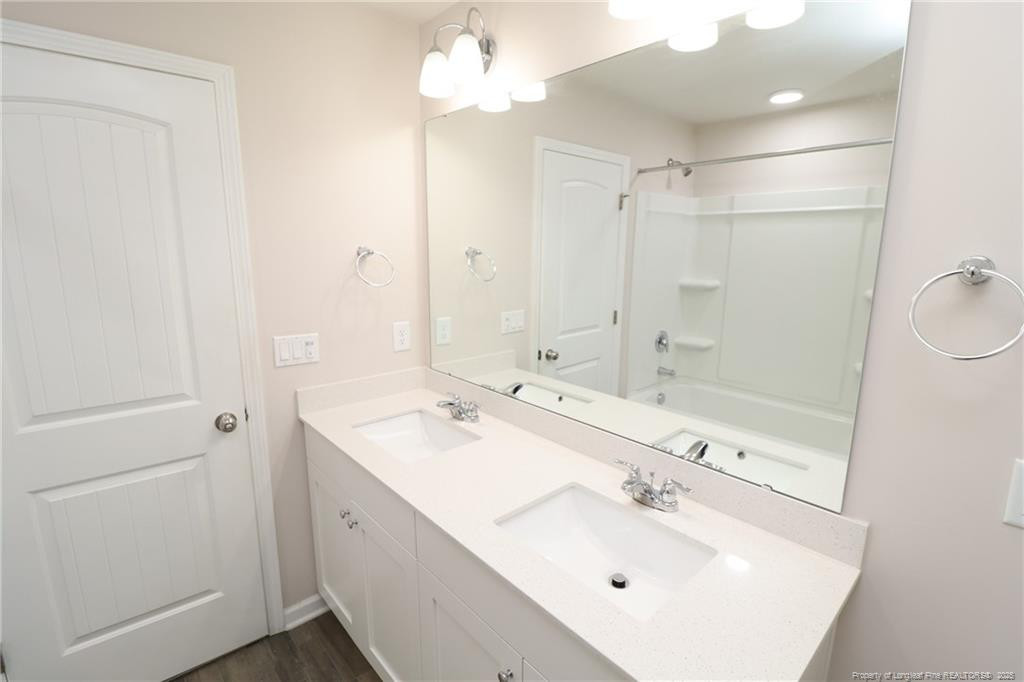 104 Kineton Woods Way Garner, NC 27529 - Photo 41 of 43 a bathroom with a sink a shower and a mirror