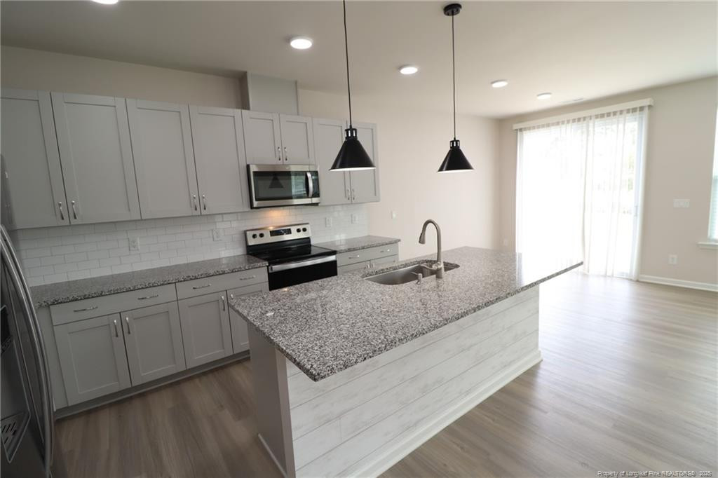 104 Kineton Woods Way Garner, NC 27529 - Photo 5 of 43 a kitchen with appliances cabinets and a wooden floor