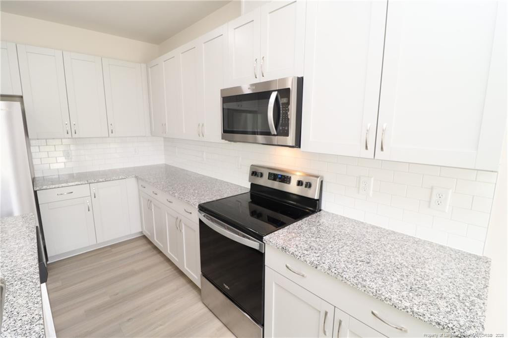 104 Kineton Woods Way Garner, NC 27529 - Photo 9 of 43 a kitchen with a sink and steel appliances