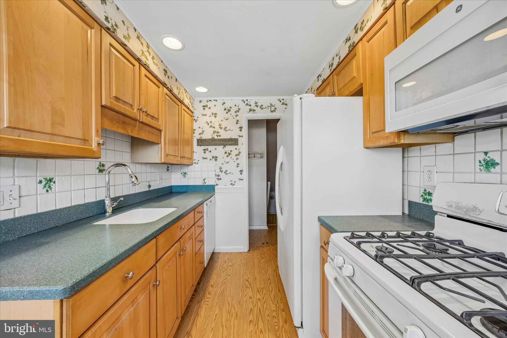3527 Primrose Road Philadelphia, PA 19114 - Photo 11 of 25 a kitchen with stainless steel appliances granite countertop a sink stove and refrigerator