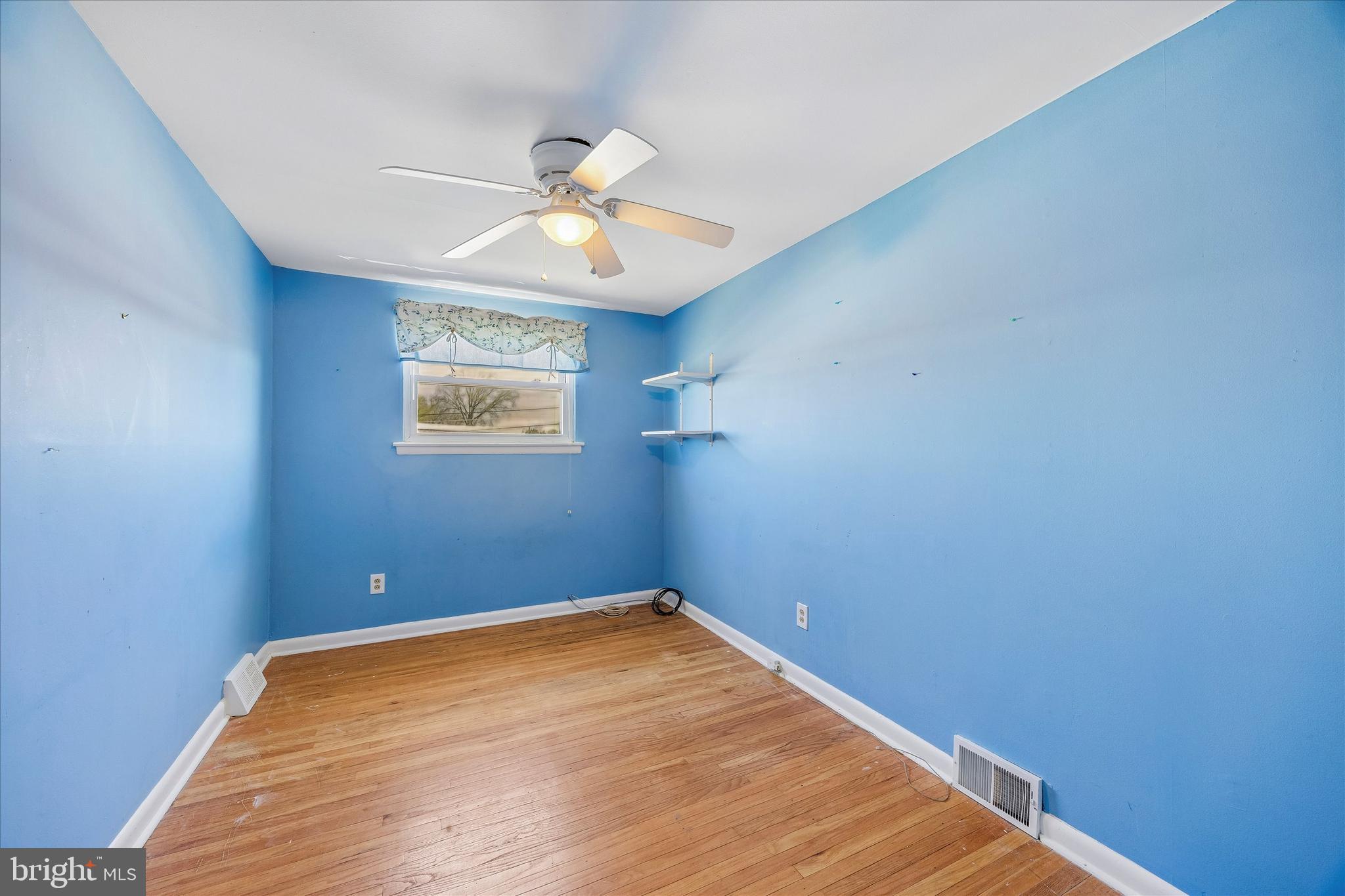 3527 Primrose Road Philadelphia, PA 19114 - Photo 19 of 25 an empty room with a window and wooden floor