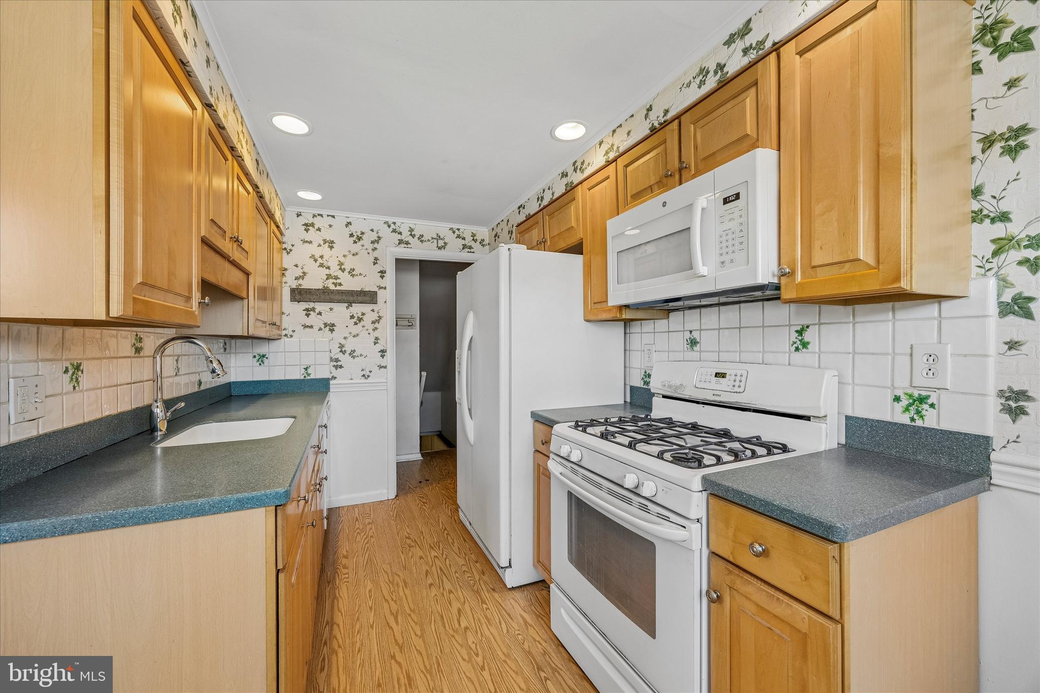 3527 Primrose Road Philadelphia, PA 19114 - Photo 10 of 25 a kitchen with stainless steel appliances granite countertop a sink stove and refrigerator