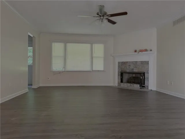 a view of an empty room with a fireplace and a window