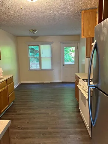 a view of a room with wooden floor and fan