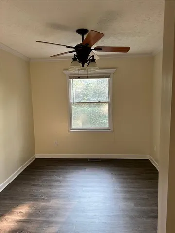 a view of room with wooden floor and fan