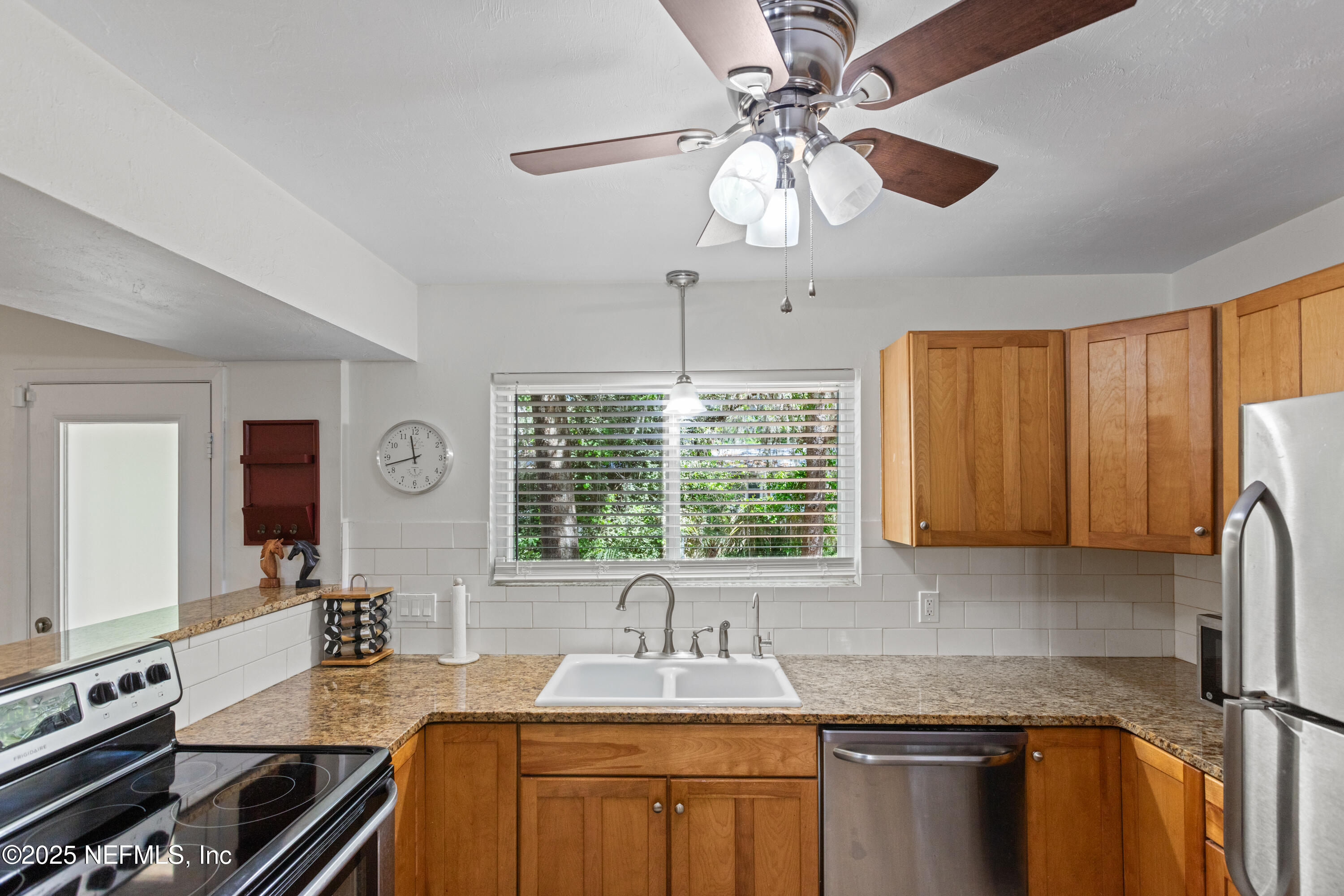 303 Southeast 3rd Avenue Melrose, FL 32666 - Photo 12 of 90 a kitchen with stainless steel appliances granite countertop a sink stove and refrigerator