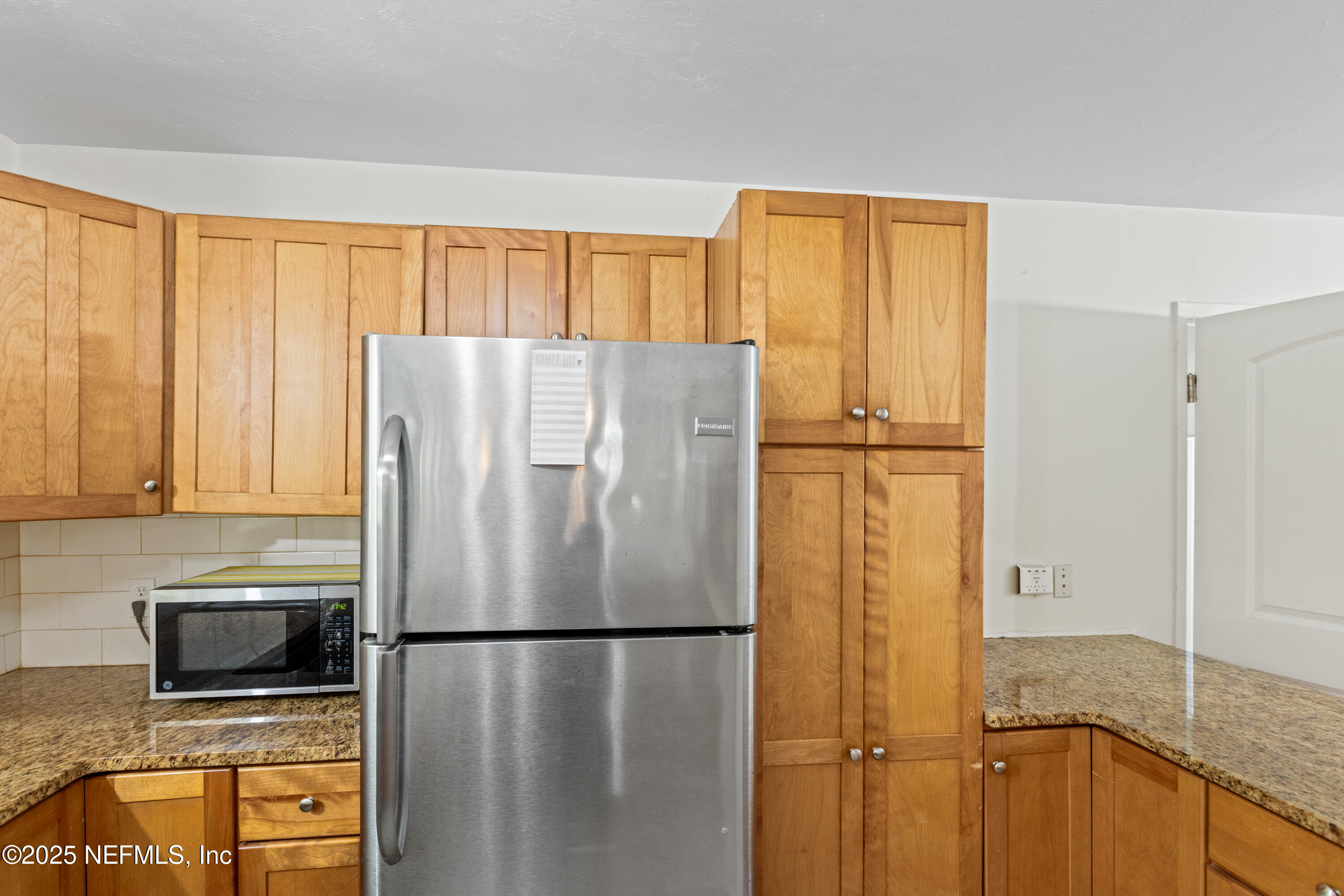 303 Southeast 3rd Avenue Melrose, FL 32666 - Photo 15 of 90 a white refrigerator freezer sitting in a kitchen