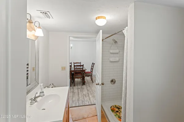 a bathroom with a sink a mirror and a window