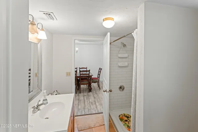 a bathroom with a sink a mirror and a window