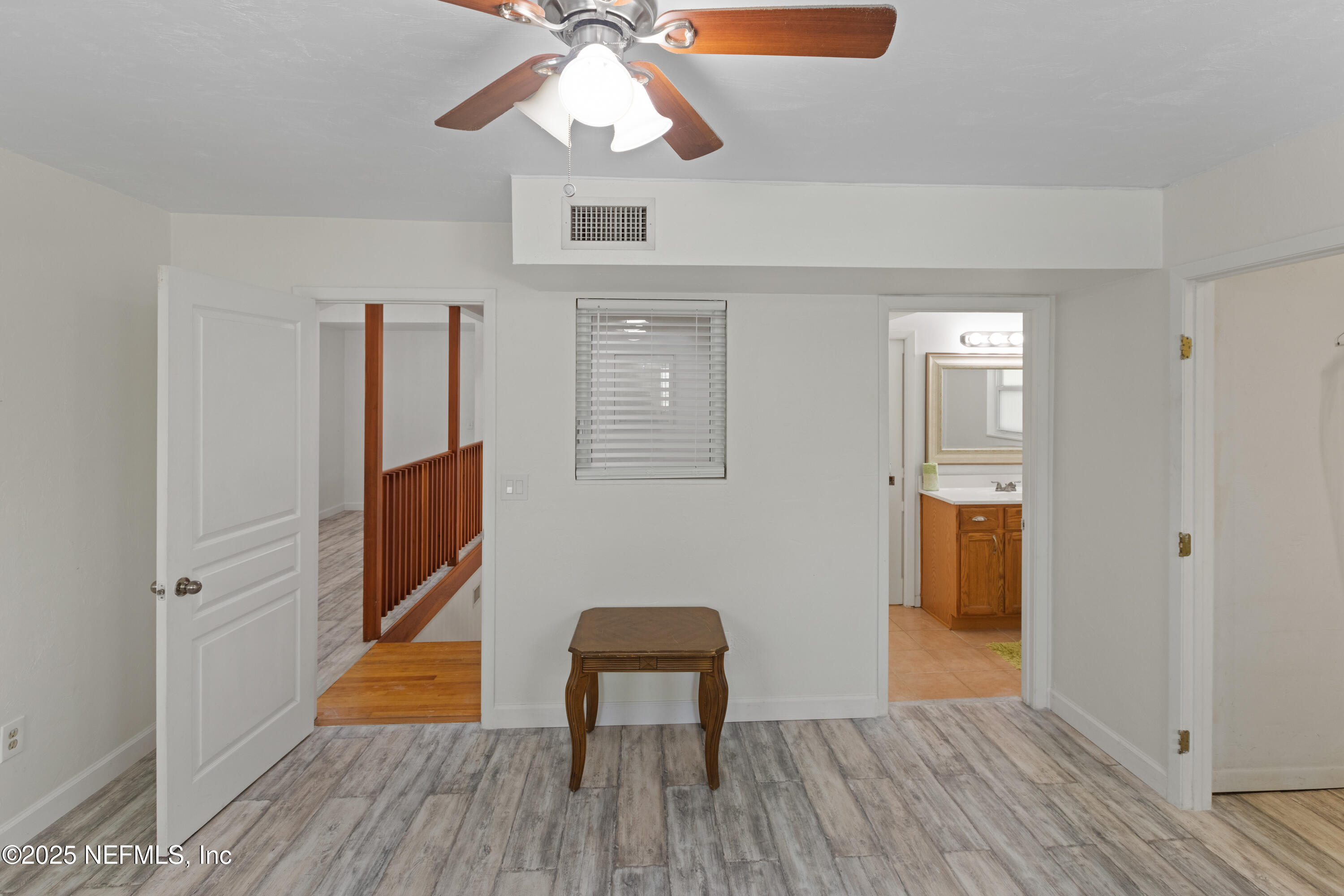303 Southeast 3rd Avenue Melrose, FL 32666 - Photo 30 of 90 a view of a livingroom with wooden floor and a ceiling fan