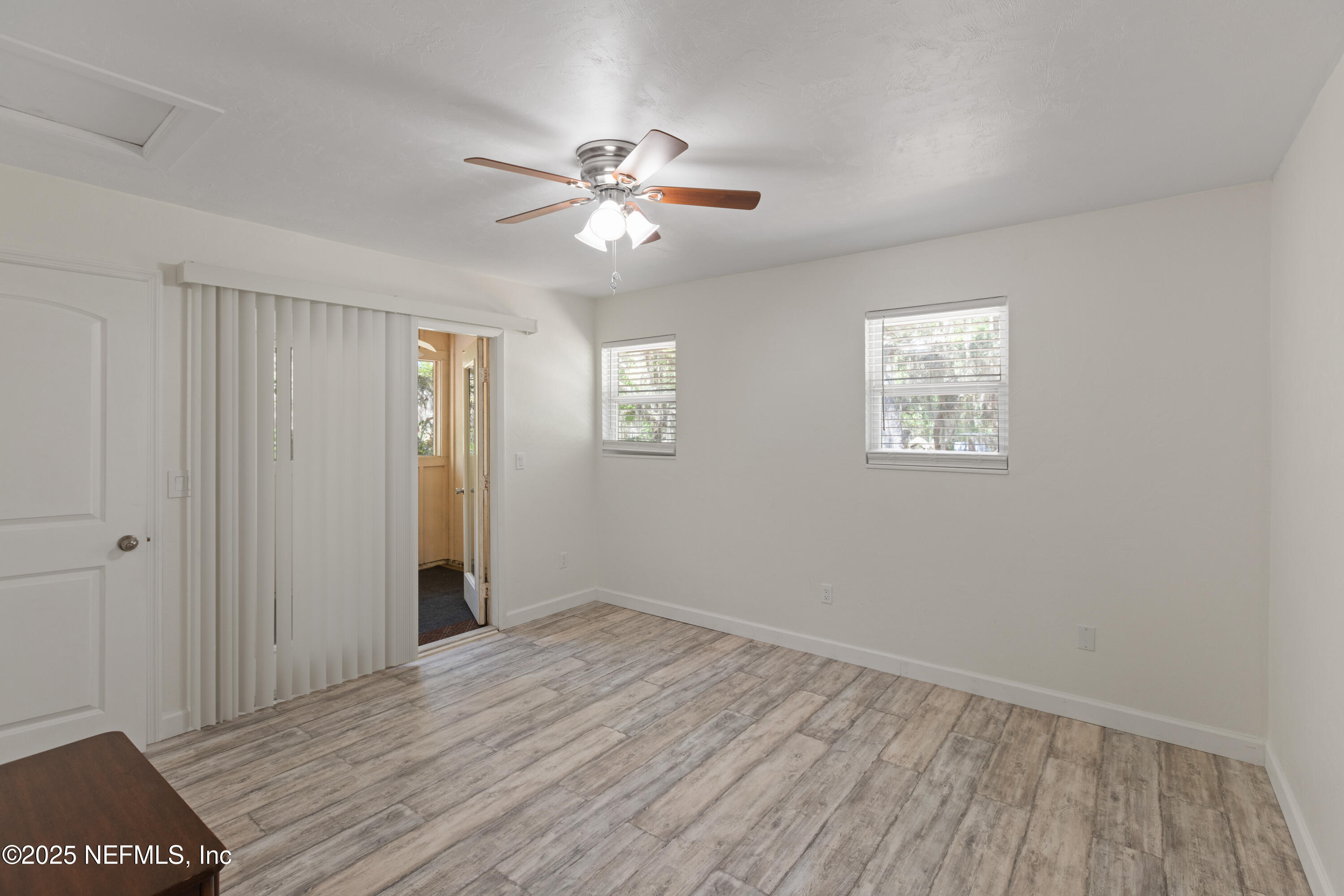 303 Southeast 3rd Avenue Melrose, FL 32666 - Photo 39 of 90 a view of an empty room with wooden floor and a window