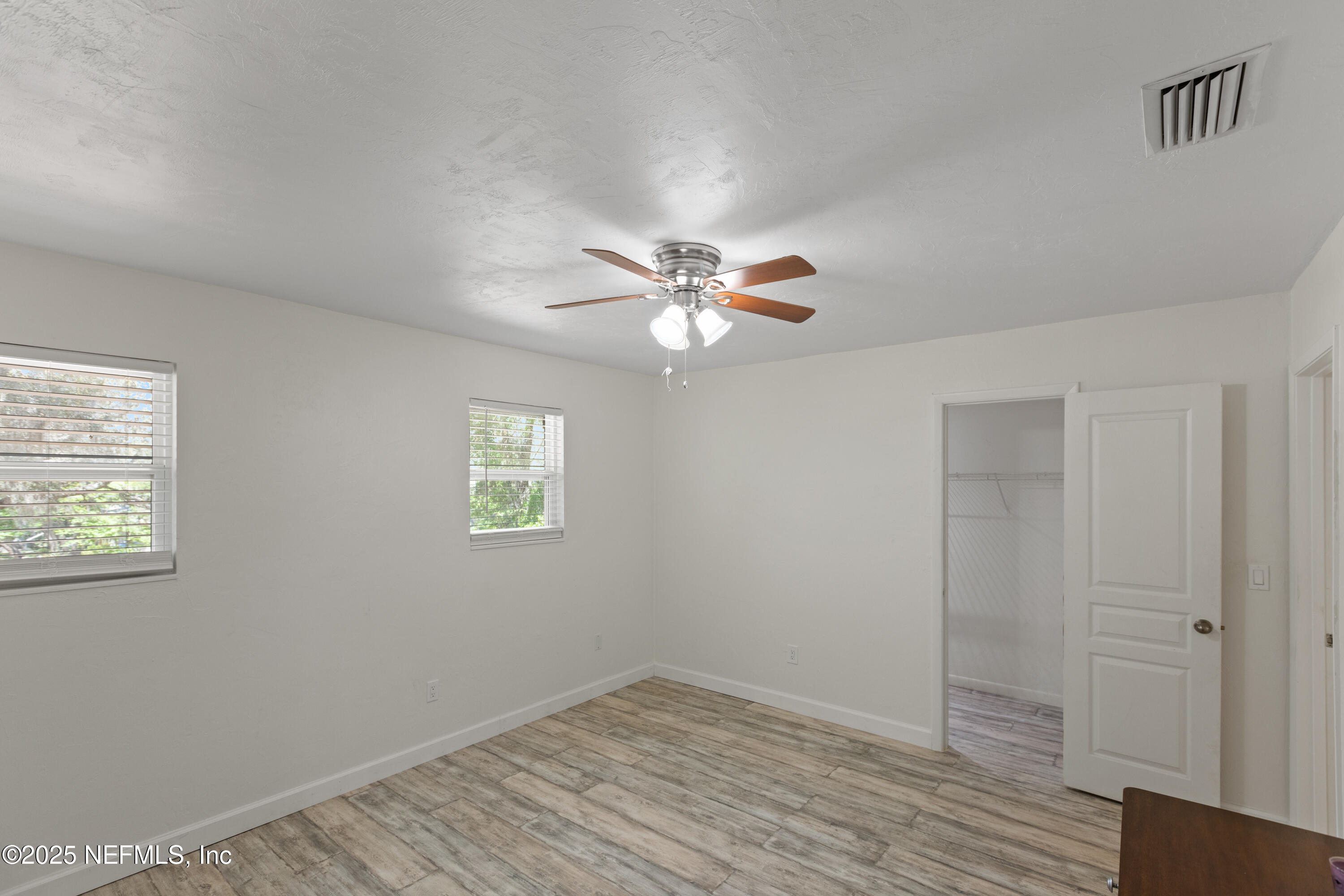 303 Southeast 3rd Avenue Melrose, FL 32666 - Photo 43 of 90 a view of an empty room with wooden floor and a window