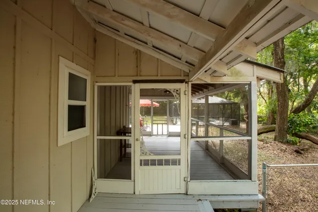 an aerial view of residential houses with outdoor space and trees