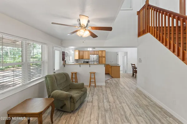 a view of staircase with wooden floor and a rug