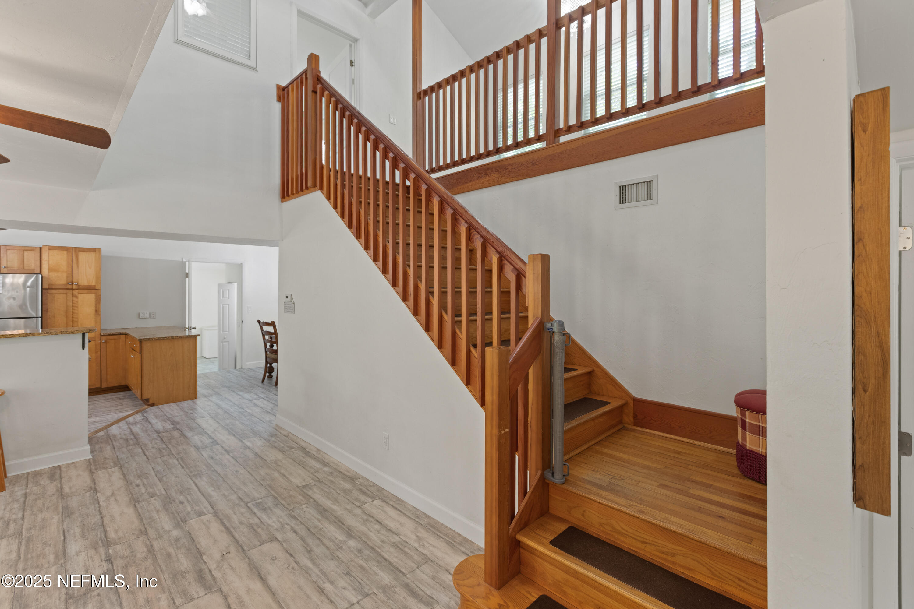 303 Southeast 3rd Avenue Melrose, FL 32666 - Photo 10 of 90 a view of staircase with wooden floor and a rug