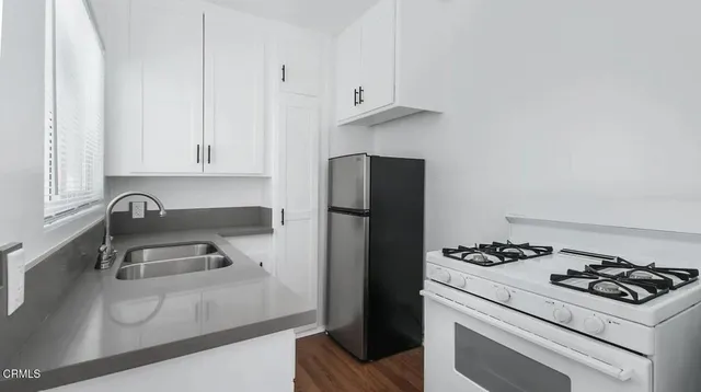 a kitchen with a sink a stove and refrigerator