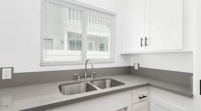 a kitchen with granite countertop a sink and a window
